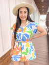 white romper with blue and orange and yellow flower print