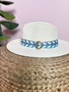 white hat with blue abstract pattern band 