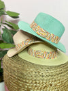turquoise, white, and natural hat with multi colored band