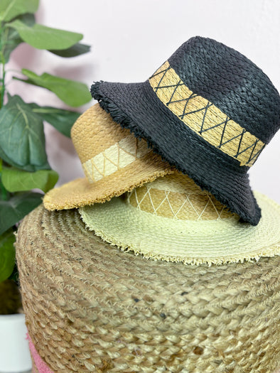 black, tan, and neutral hat with frayed edge 