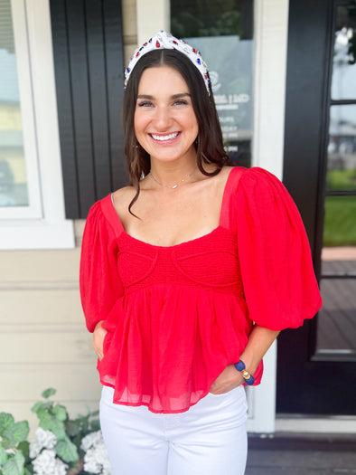 red smocked top with flowy sleeves