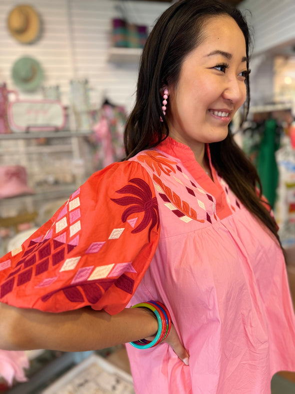 sleeve of pink and orange embroidered top 