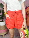 red orange shorts with scallop detail and belt 