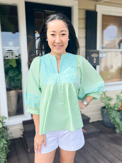 green gingham top with blue embroidery 