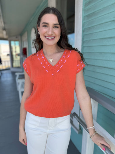 orange v neck short sleeve top 
