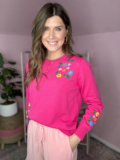 pink sweater with embroidered flowers 