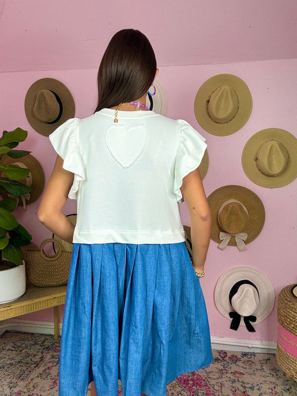 heart detail on the back of denim dress with off white top 