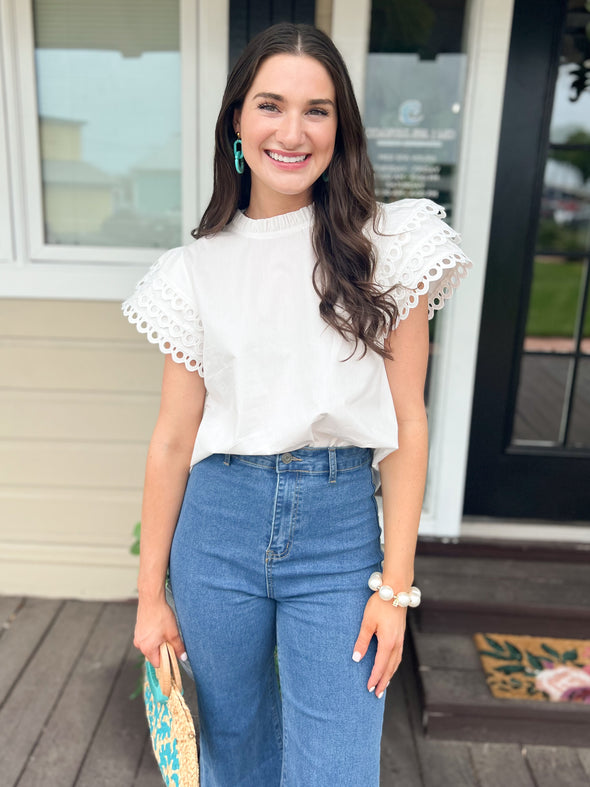 white top with eyelet ruffle sleeves