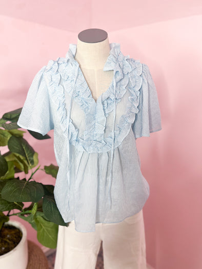light blue and white top with ruffled front 