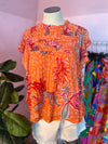 orange top with floral pattern 