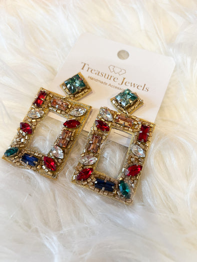 holiday earrings with red, clear, blue, and green stones