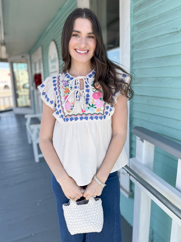 white and blue and pink embroidered THMl top 
