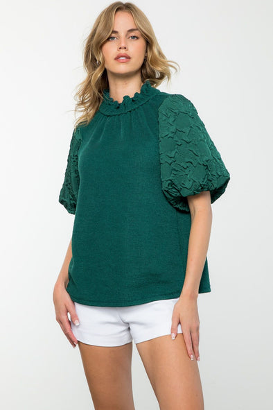 hunter green top with statement floral sleeves