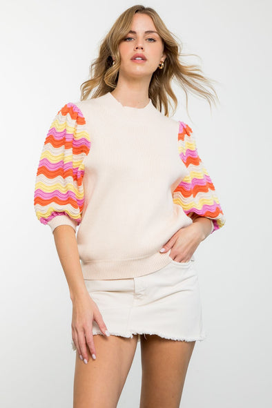 cream top with knit sleeves